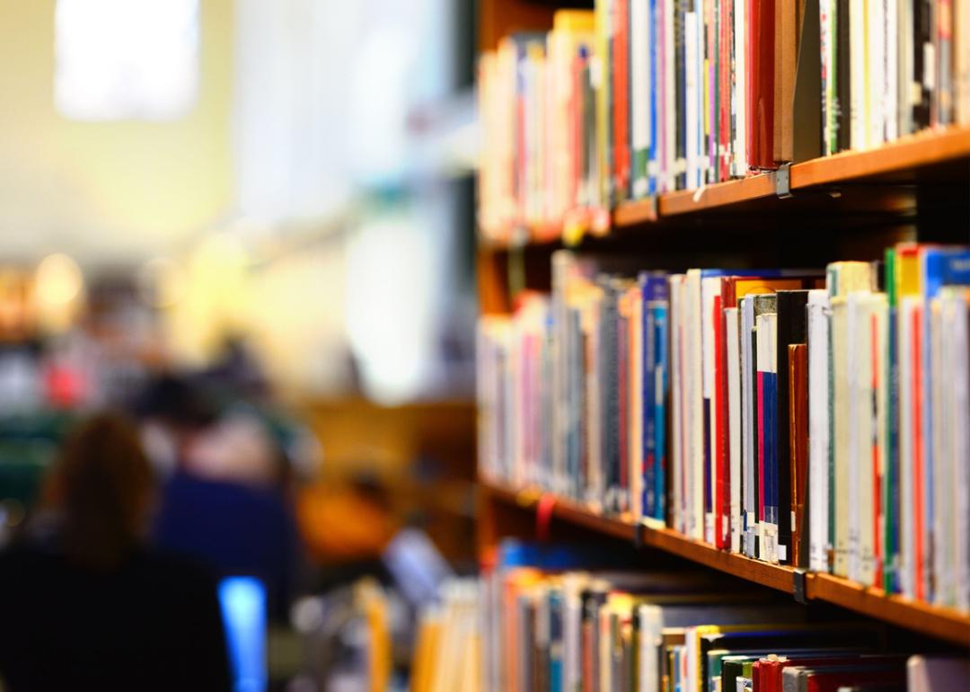 Selective focus of books on library shelf.