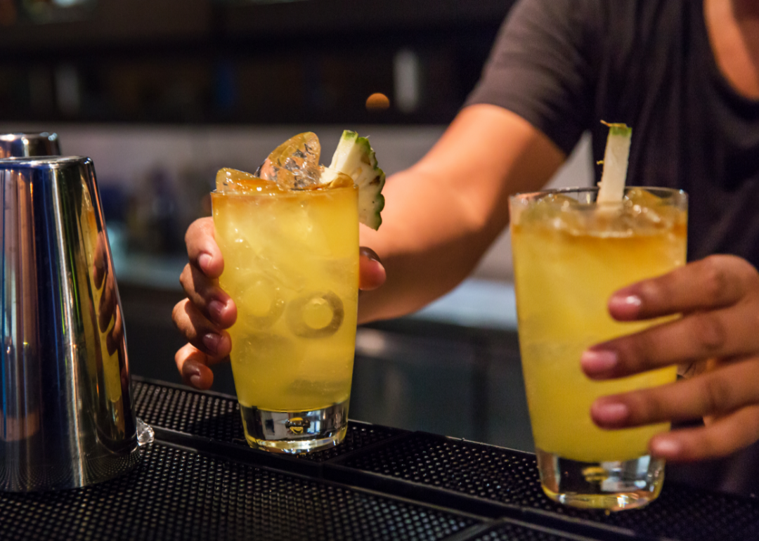 Bartender serving buy-one-get-one cocktails.