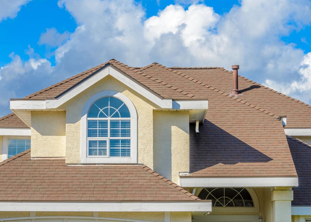 Detail of house against cloudy sky.