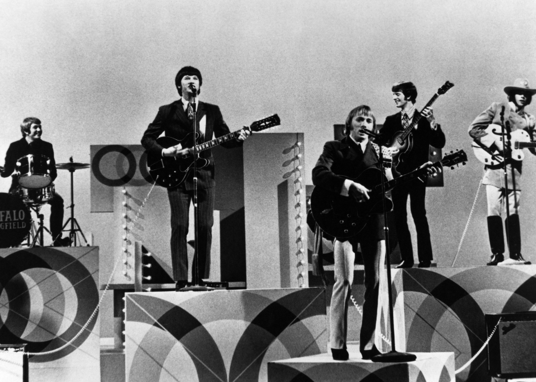 Neil Young, Stephen Stills, and Buffalo Springfield performing on stage.