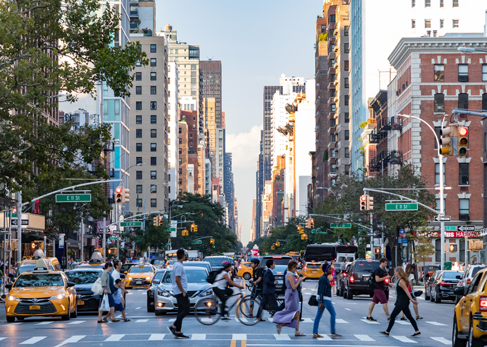People walk across 3rd Avenue in Manhattan during rush hour traffic.