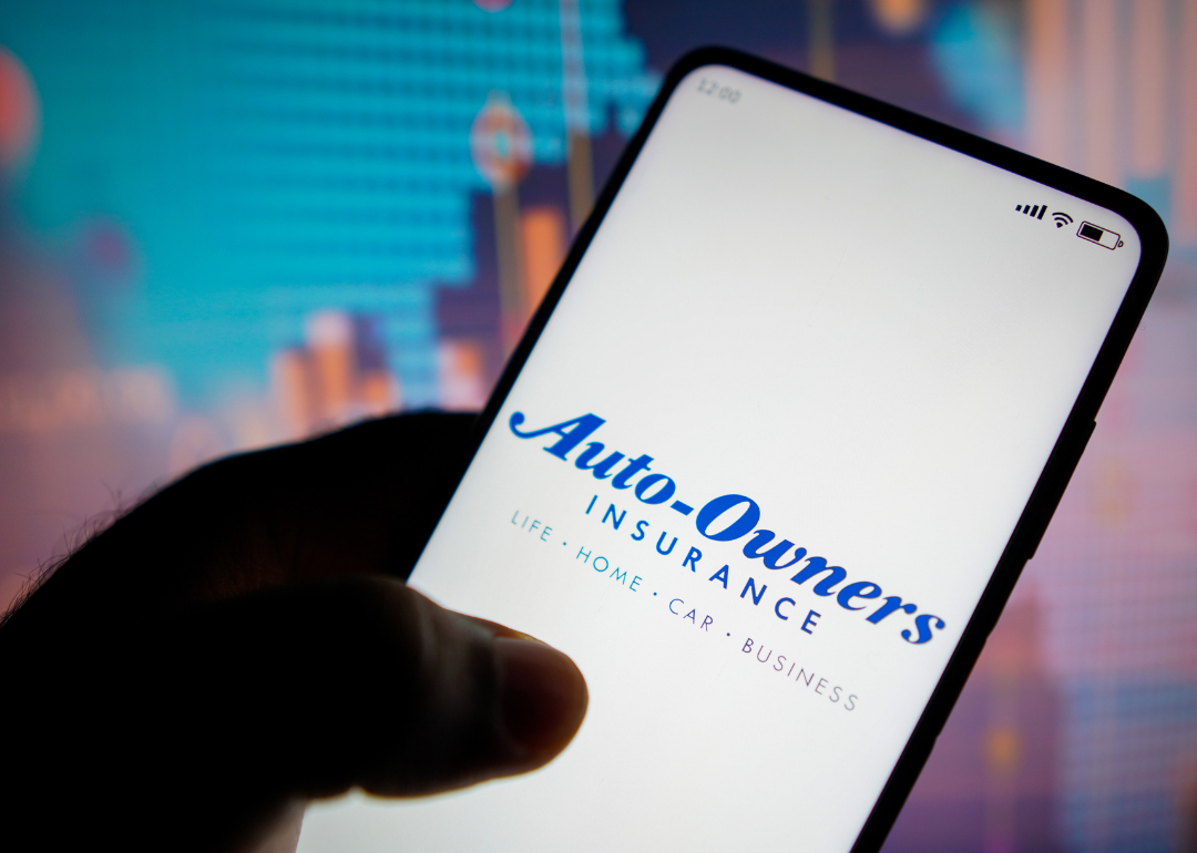 Auto-Owners Insurance logo on phone.