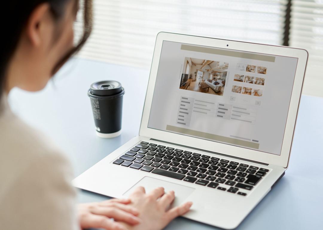 Person looking at apartment listing on laptop.