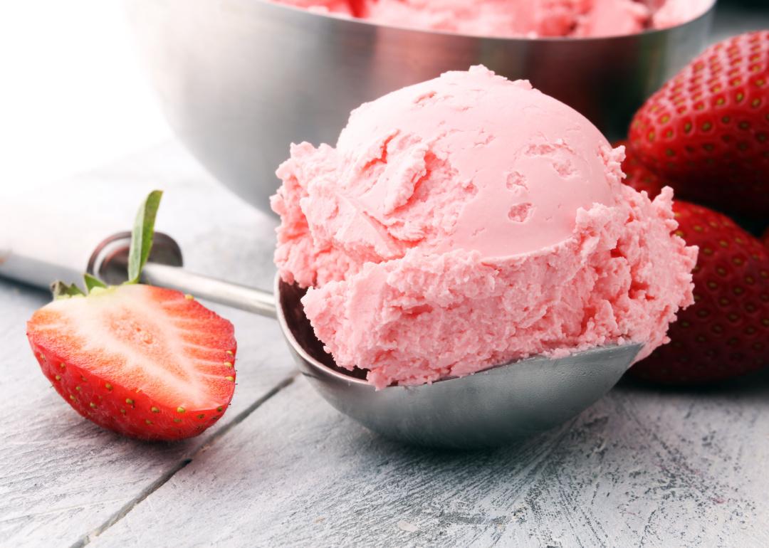 Close up fresh strawberry and scoop of strawberry ice cream.