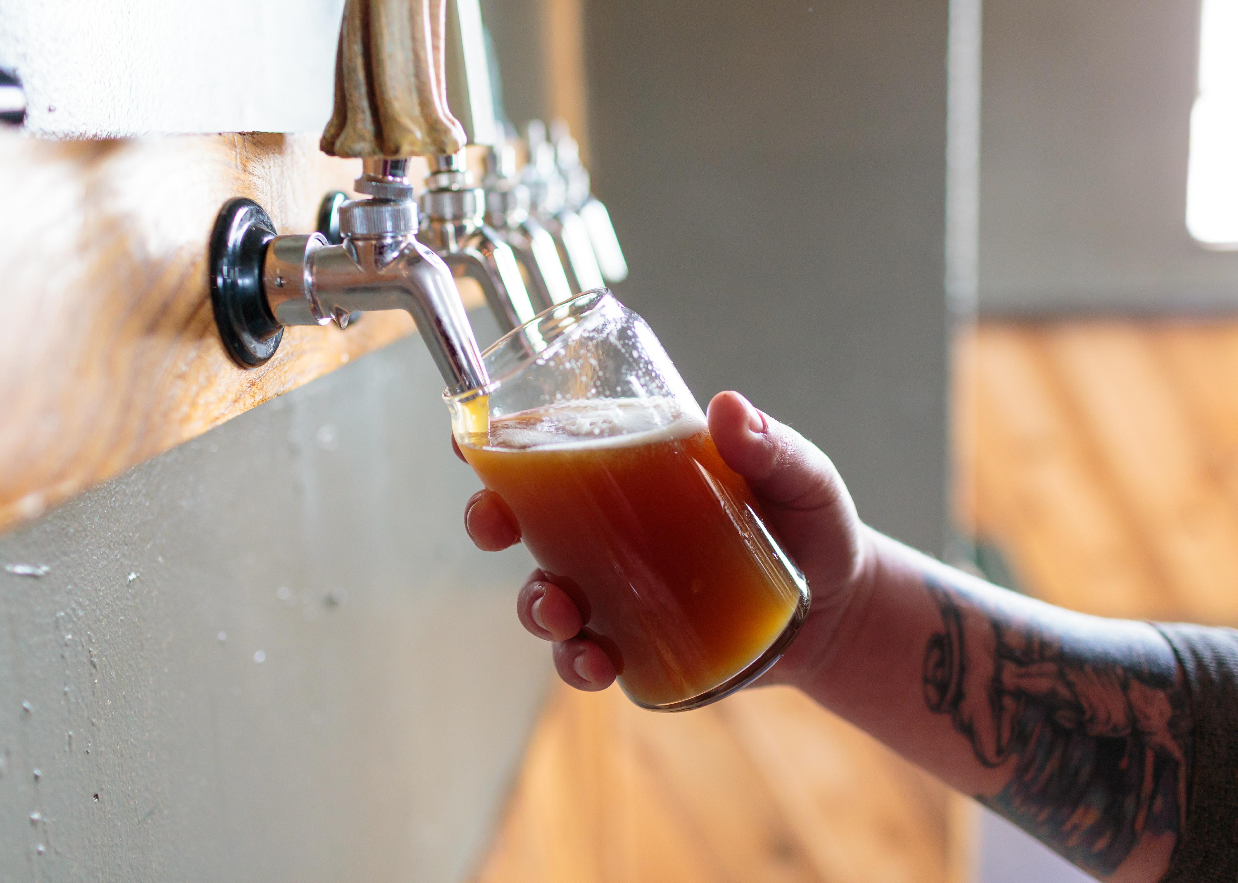 Bartender pouring IPA on tap.