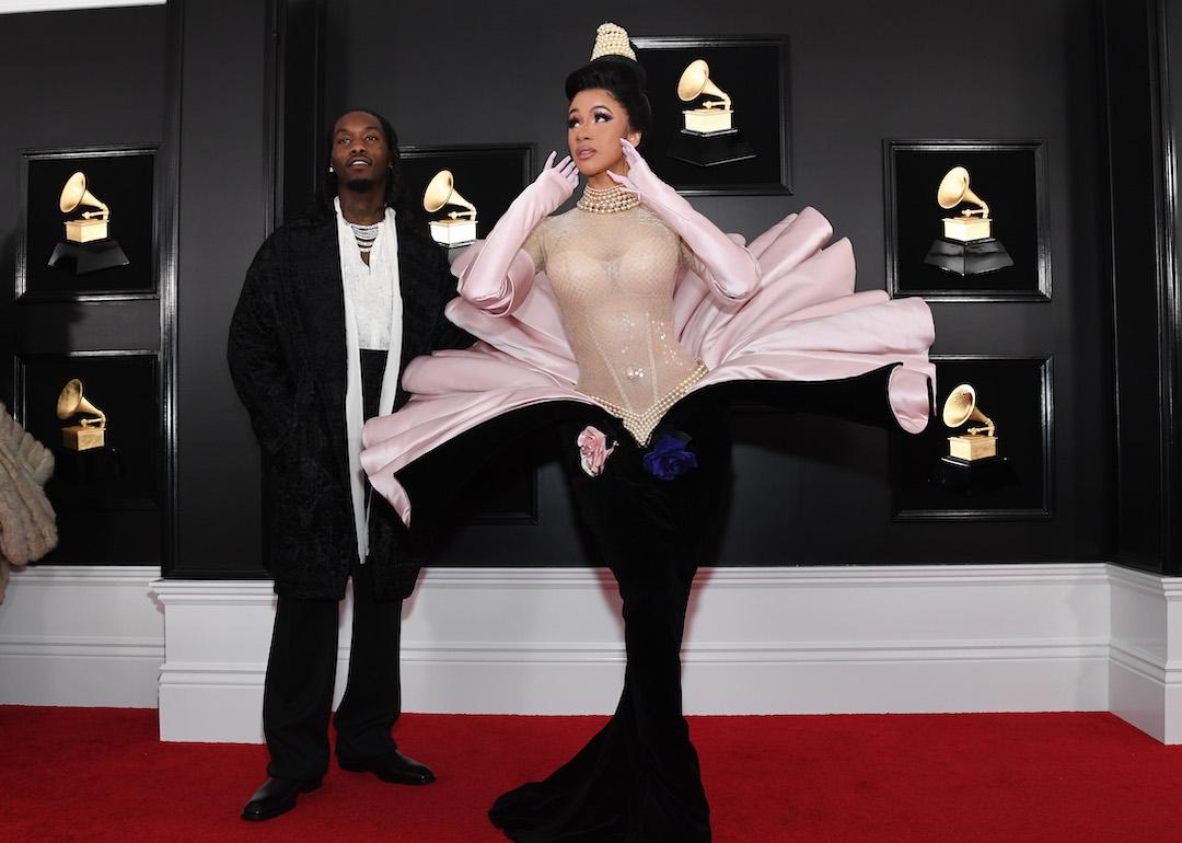 Offset stands behind Cardi B, who is dressed as a pearl in an oyster shell gown, at the 2019 Grammy Awards.