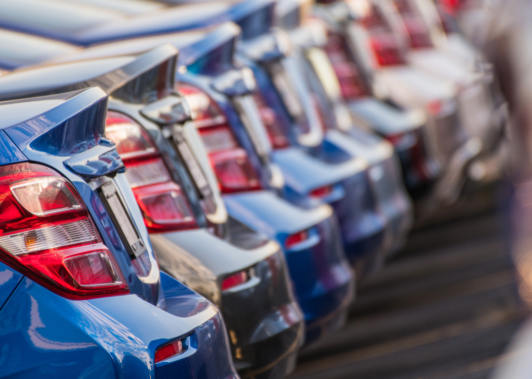 A row of brand new cars in different colors of the same make.