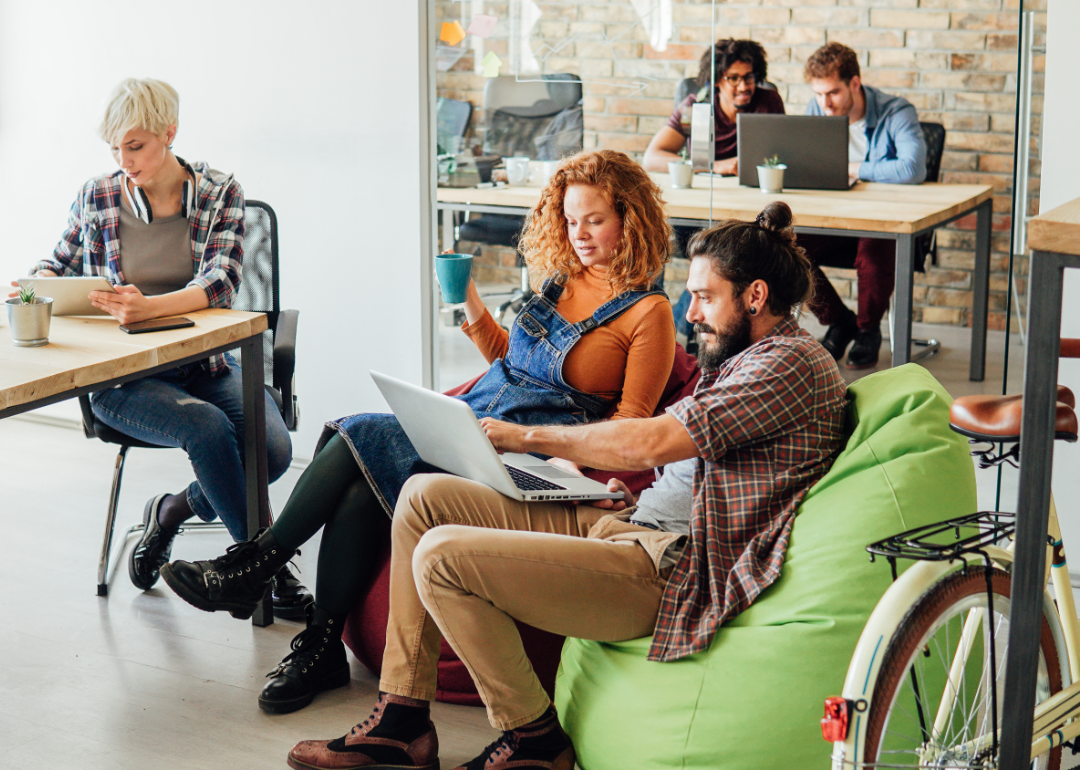 Office workers socialize in a contemporary work space.