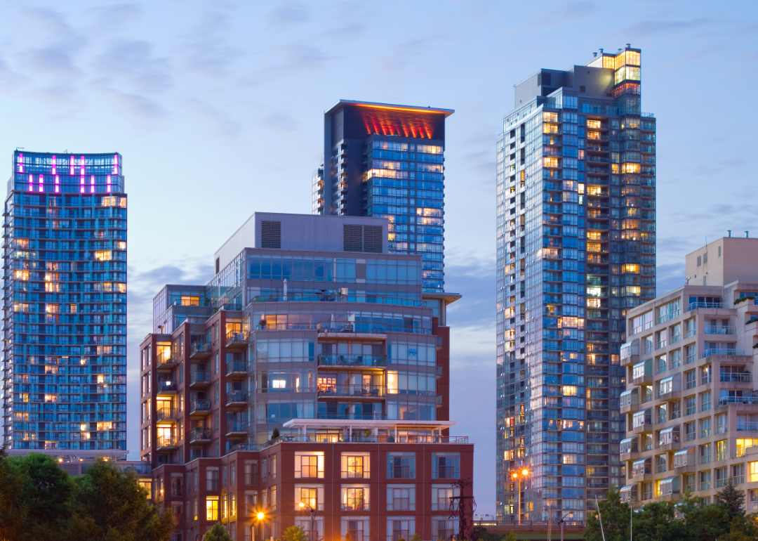 Residential buildings in the foreground and office buildings in the background of a cityscape.