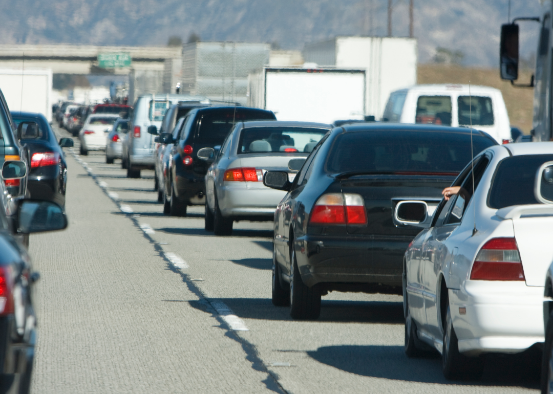 Cars lined up on a highway.