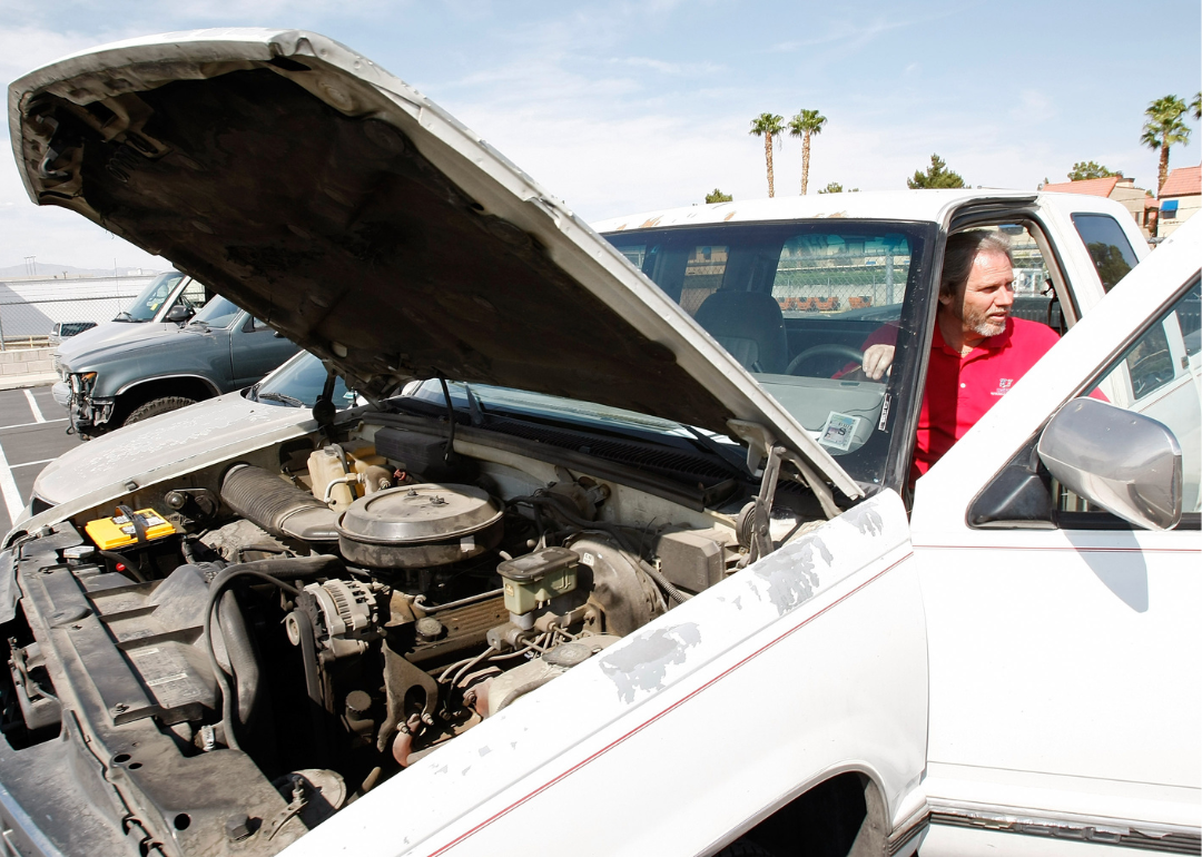 A  service manager runs the engine of a 1993 Chevrolet Silverado 1500 pickup truck.