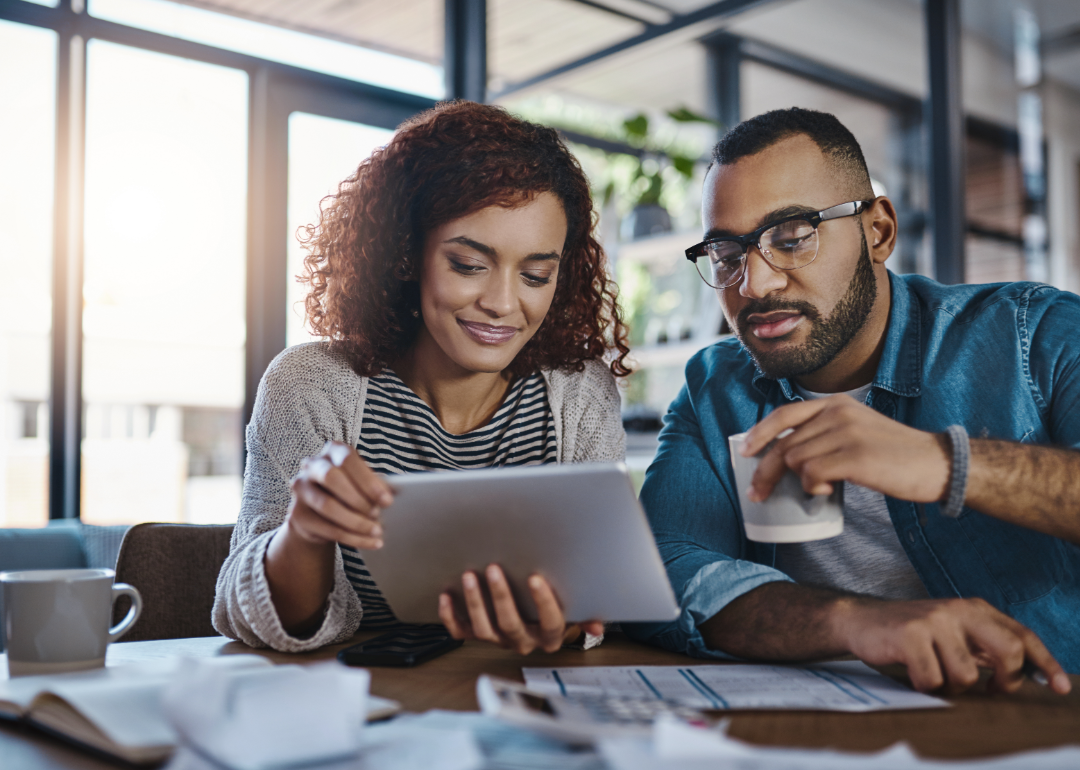 A couple reviews their finances online.