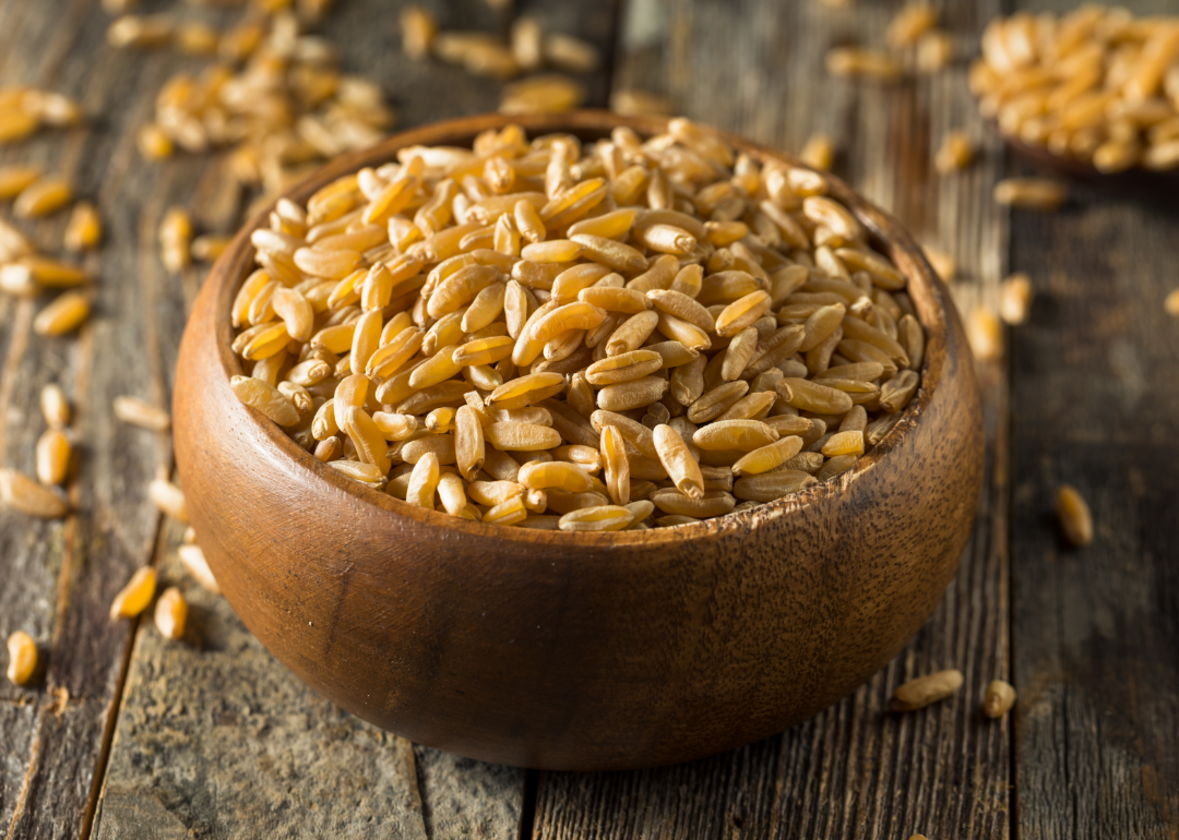 Dry brown organic khorasan wheat in a bowl.