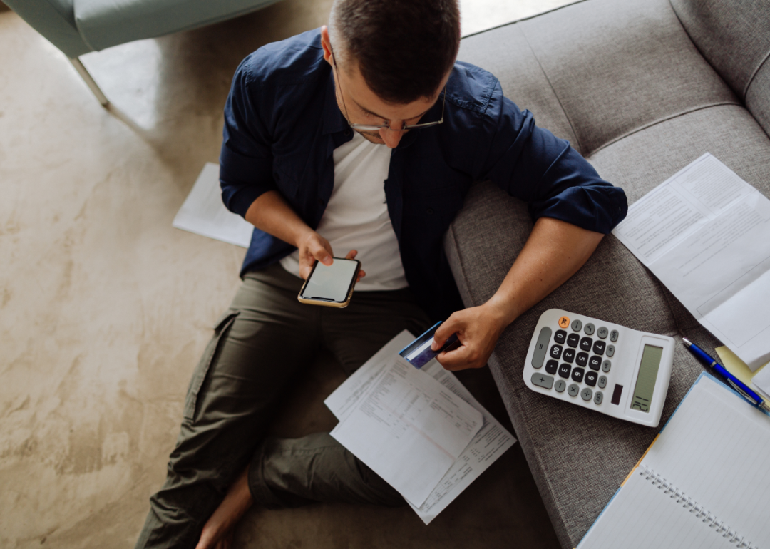 A person at home paying bills online.