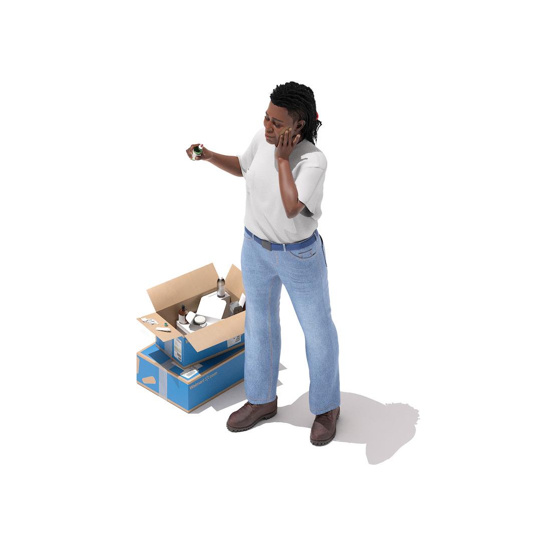 A person stands next to a group of boxes piled on the floor.