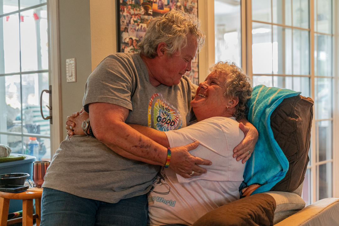 Two people cuddling in a chair.