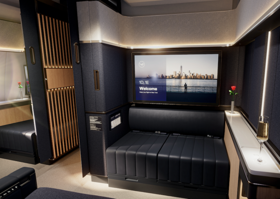 The interior of a private suite on Lufthansa Airlines that includes seats that fold out into a bed.