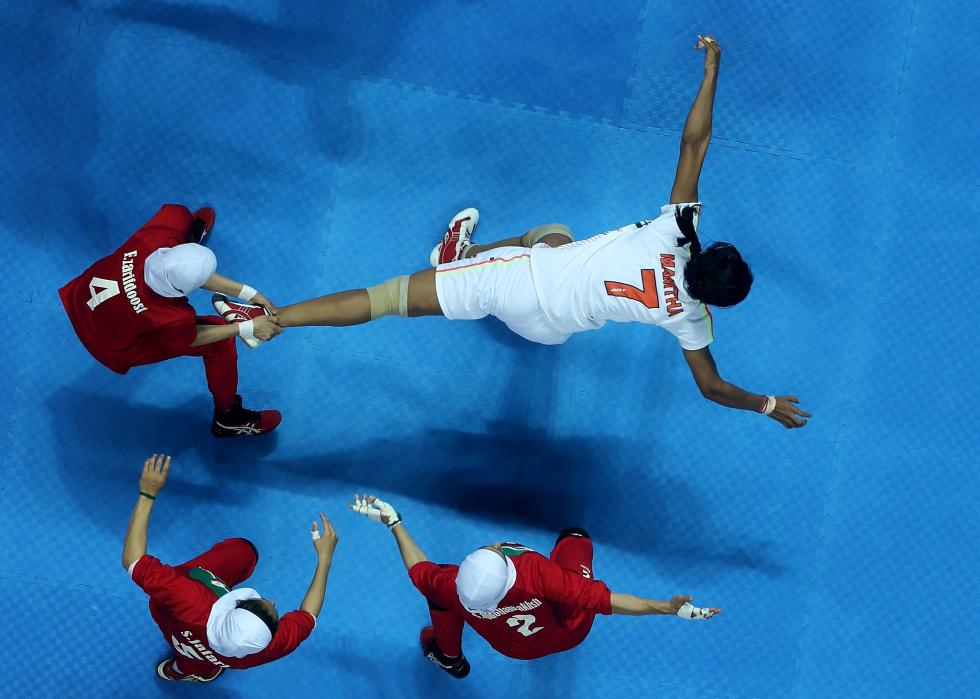 Mamatha Mamatha #7 of Independent Olympic Athletes is caught by Zarif Doost Farideh #4 of Iran during the Women's Kabaddi Gold Medal match at Ansan Sangnoksu Gym on day five of the 4th Asian Indoor & Martial Arts Games on July 3, 2013 in Incheon, South Korea