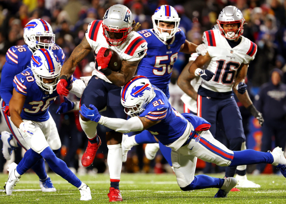 Jordan Poyer #21 of the Buffalo Bills attempts to tackle Brandon Bolden #25 of the New England Patriots during the game at Highmark Stadium on December 06, 2021 in Orchard Park, New York.