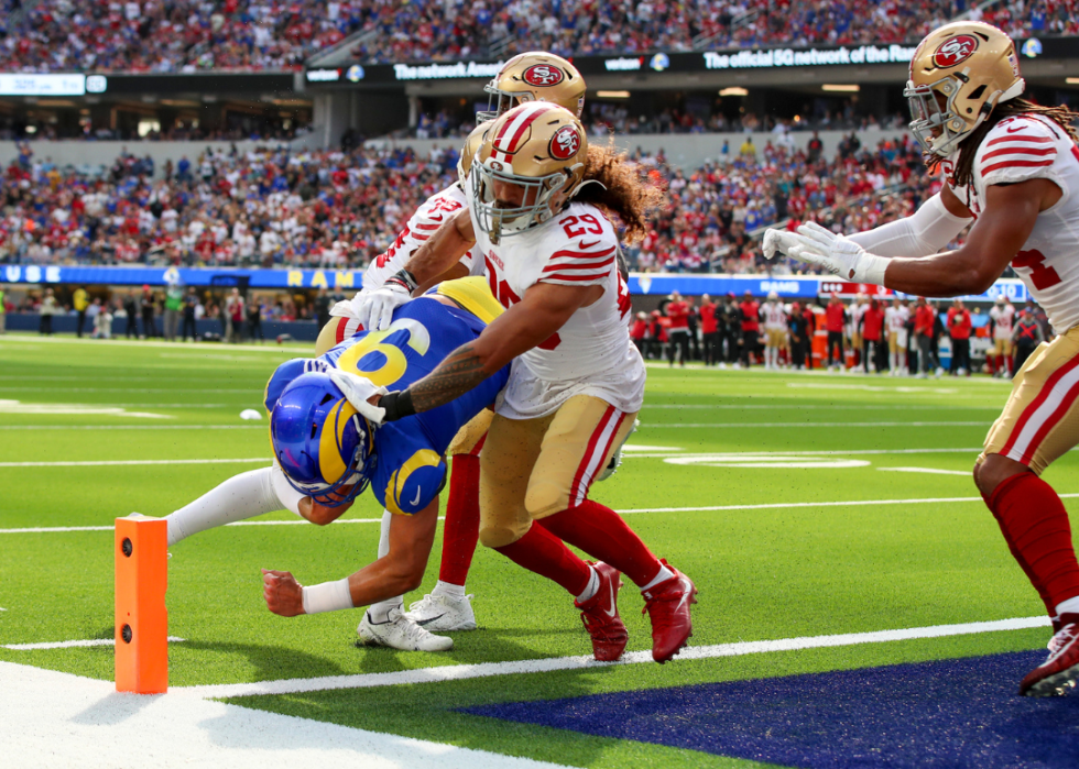 Rams quarterback Matthew Stafford, #9, dives into the end zone for a touchdown past 49ers defensive back Deommodore Lenoir, left, and safety Talanoa Hufanga in the first quarter at SoFi Stadium, Inglewood, CA on Sunday, Oct. 30, 2022.