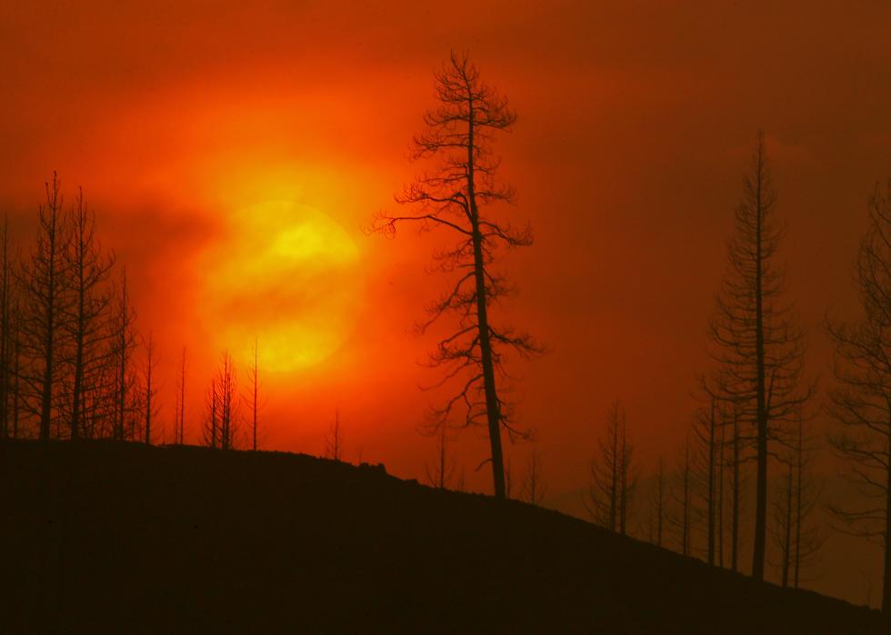 Smoke obscures the sun as it sets on the burn zone of the McKinley fire near Yreka, California, on August 1, 2022.