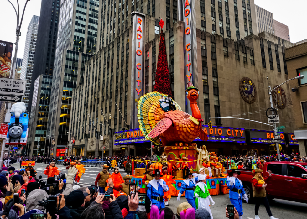 The annual Macy's Thanksgiving Day parade along Avenue of Americas with many balloons floating in the air. Manhattan, New York, USA - November 27, 2014.