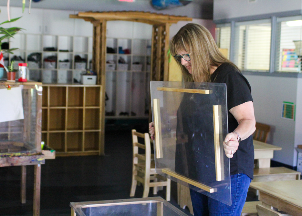 Lorraine Trulsen, owner of the Heritage Park Child Care Centre, prepares materials for children at her program in British Columbia.