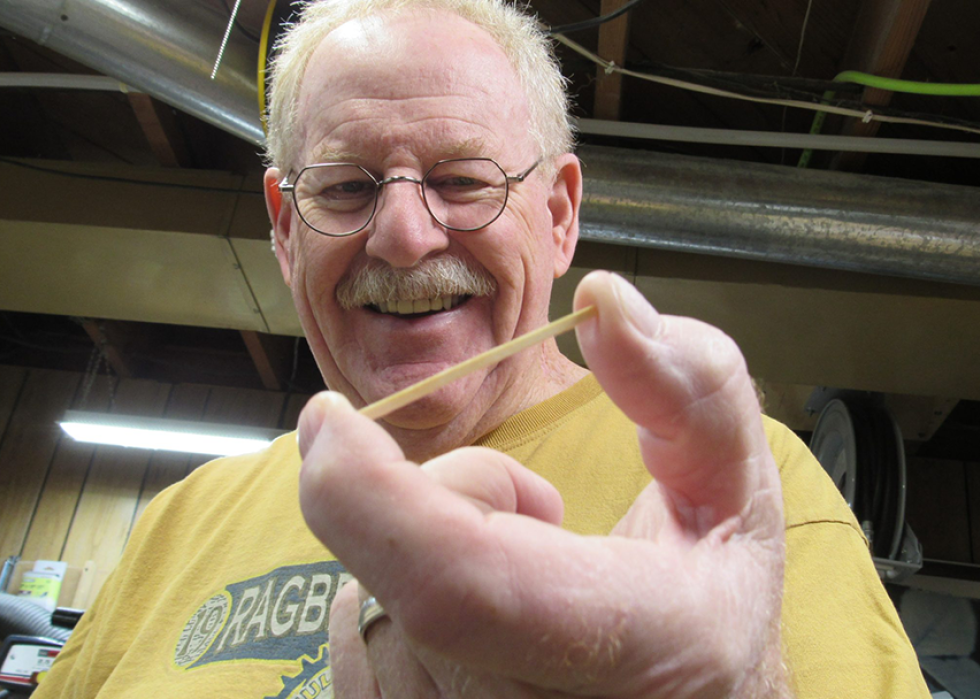 Pat Acton holding his favorite medium of artistic expression – a humble matchstick.