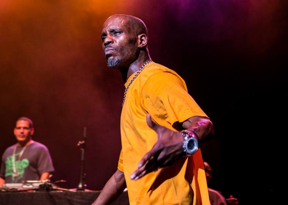 Rapper DMX performing onstage in yellow T-shirt.