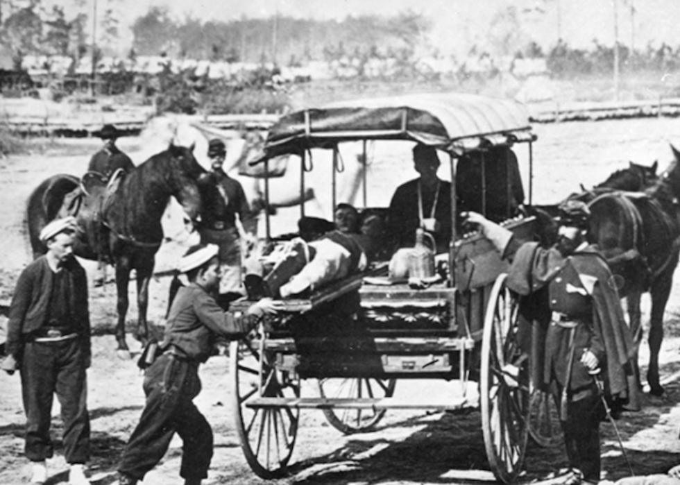 Members of the Fifth Regiment New York Volunteers conduct an ambulance drill.