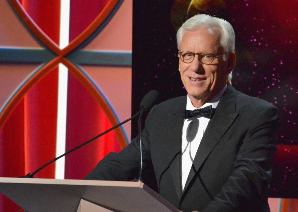 James Woods speaking onstage.