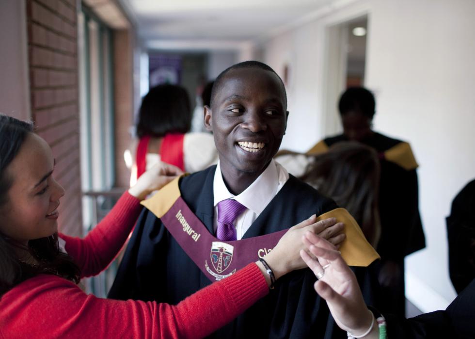 Joseph Munyambanza, a student from the Democratic Republic of Congo gets dressed before the African Leadership Academy (ALA) graduation day ceremony in the school in Honeydew, west of Johannesburg, South Africa.