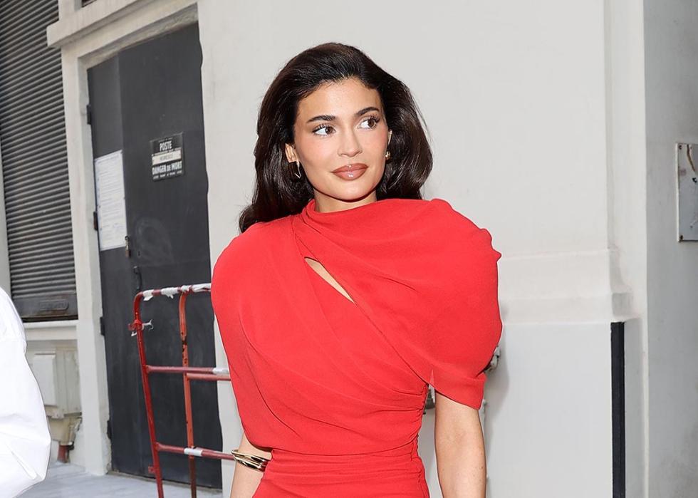 Kylie Jenner wearing a red dress leaving her hotel in France.