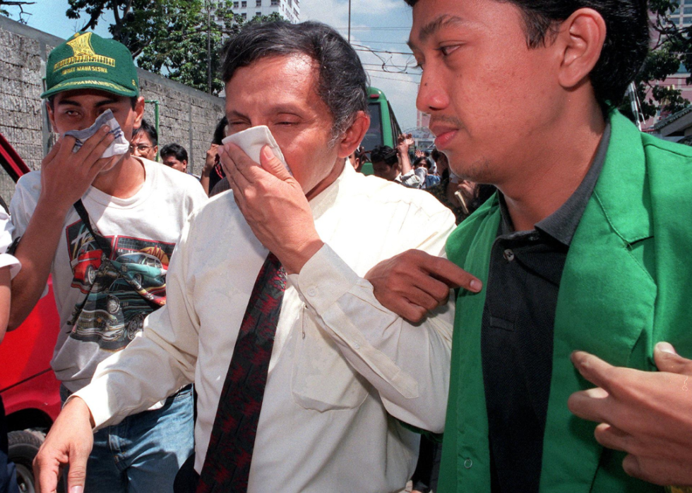 People cover their mouths and noses with hankerchiefs. 