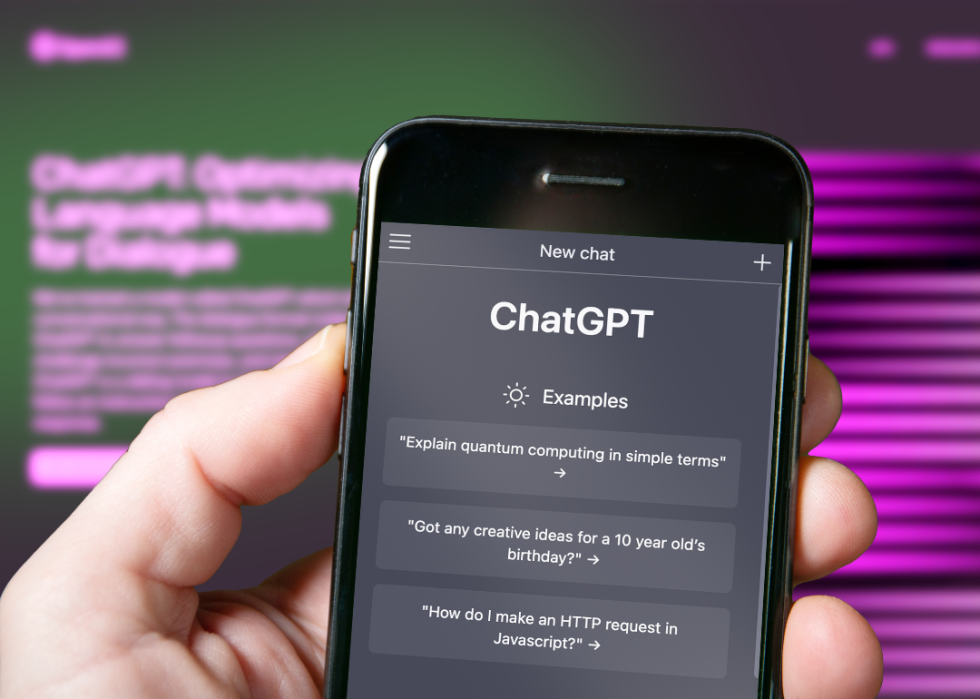 A person's hand holding a phone with ChatGPT pulled up on the screen.