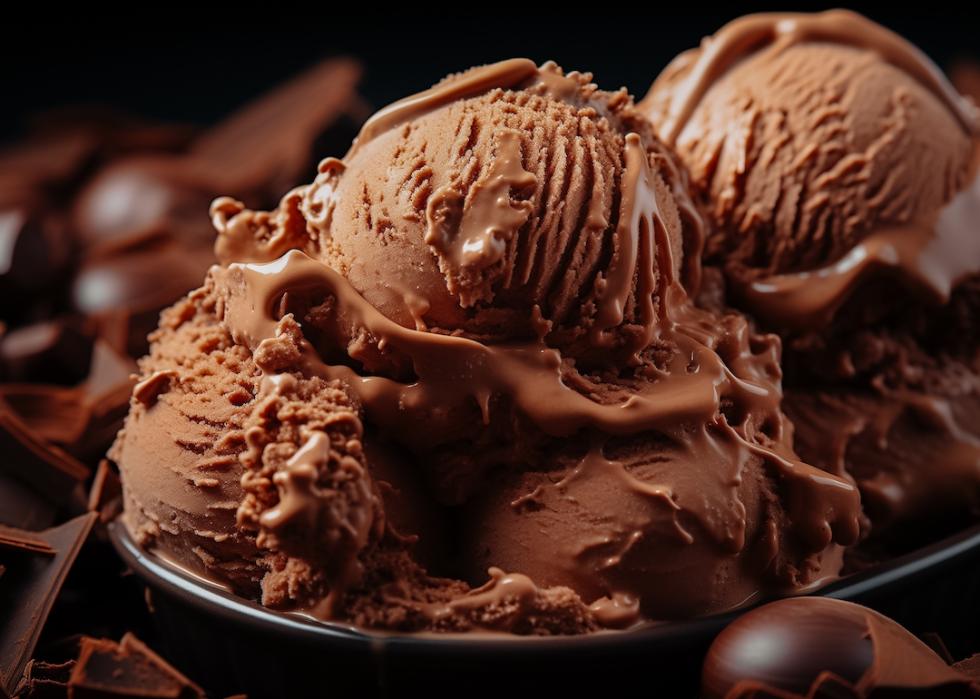 Scoop of brownie ice cream in a black bowl.