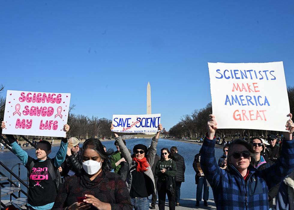 Demonstrators hold up signs during the "Stand Up For Science" rally at the Lincoln Memorial in Washington, D.C., on March 7, 2025.