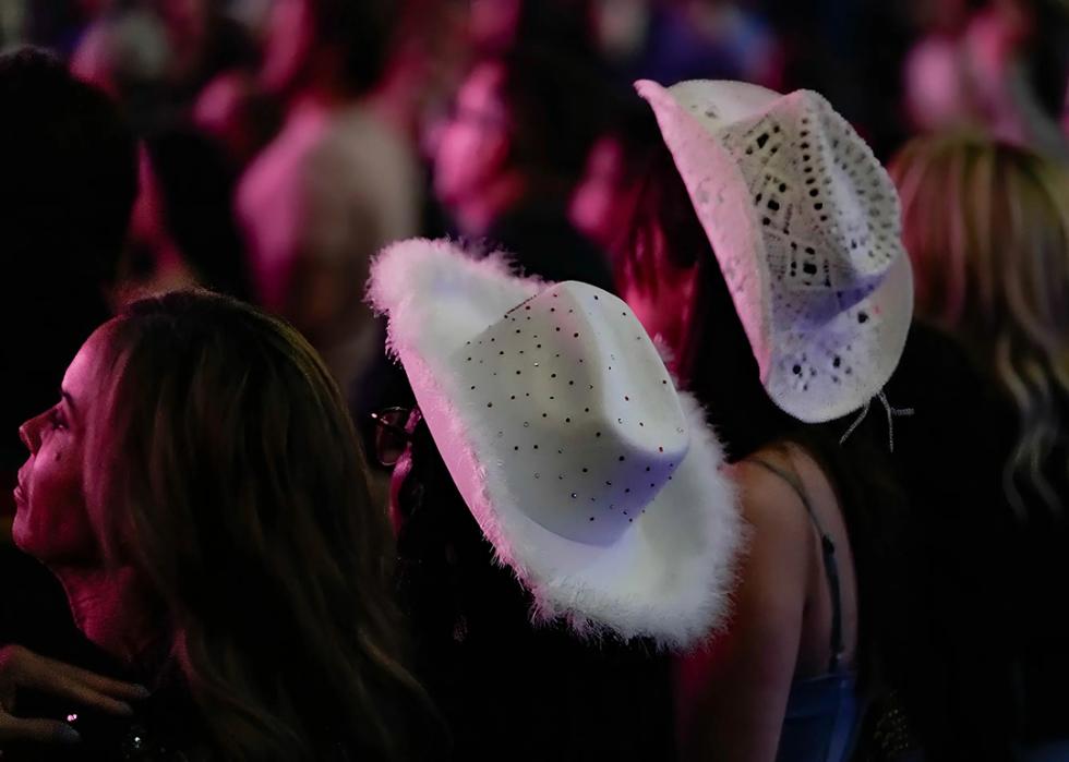 Fans wearing cowboy hats during Kelsea Ballerini's concert.
