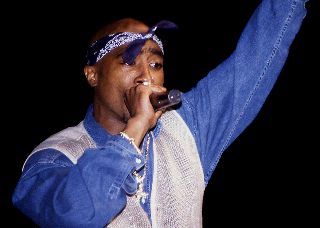 Tupac Shakur performs onstage.