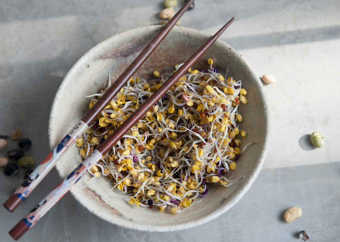 Soybean sprouts in bowl with chopsticks.