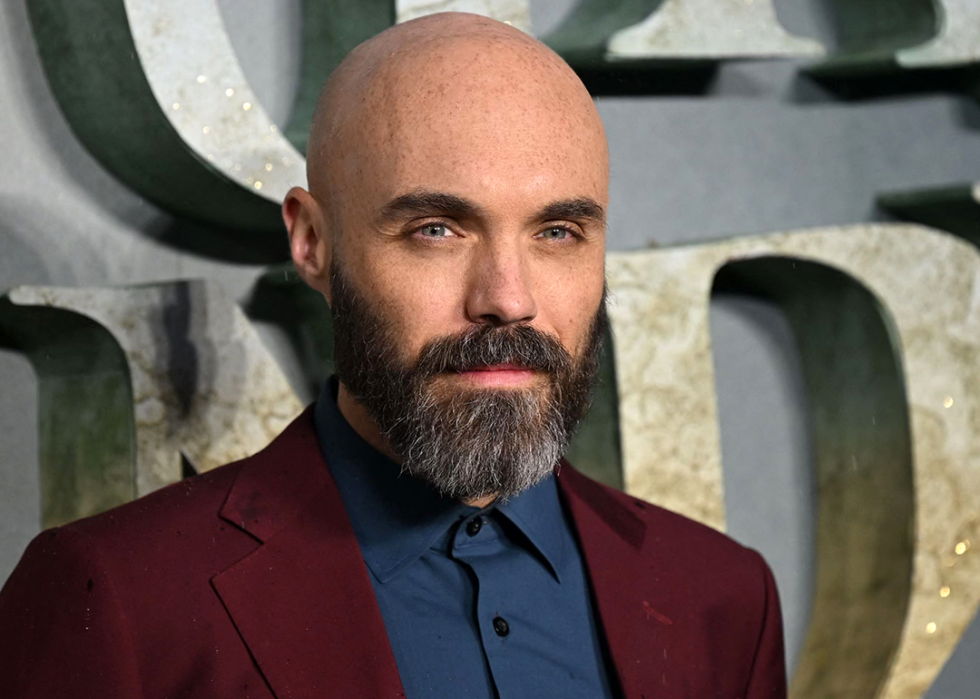 David Lowery poses on the red carpet.