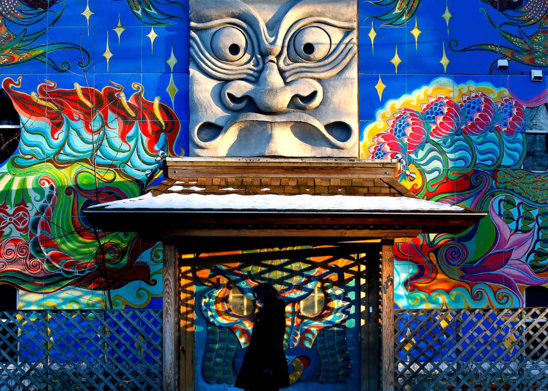 A woman walks by the exterior of the Museum of Modern Renaissance.