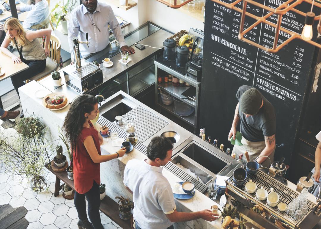 Overhead view of patrons at coffee counter.