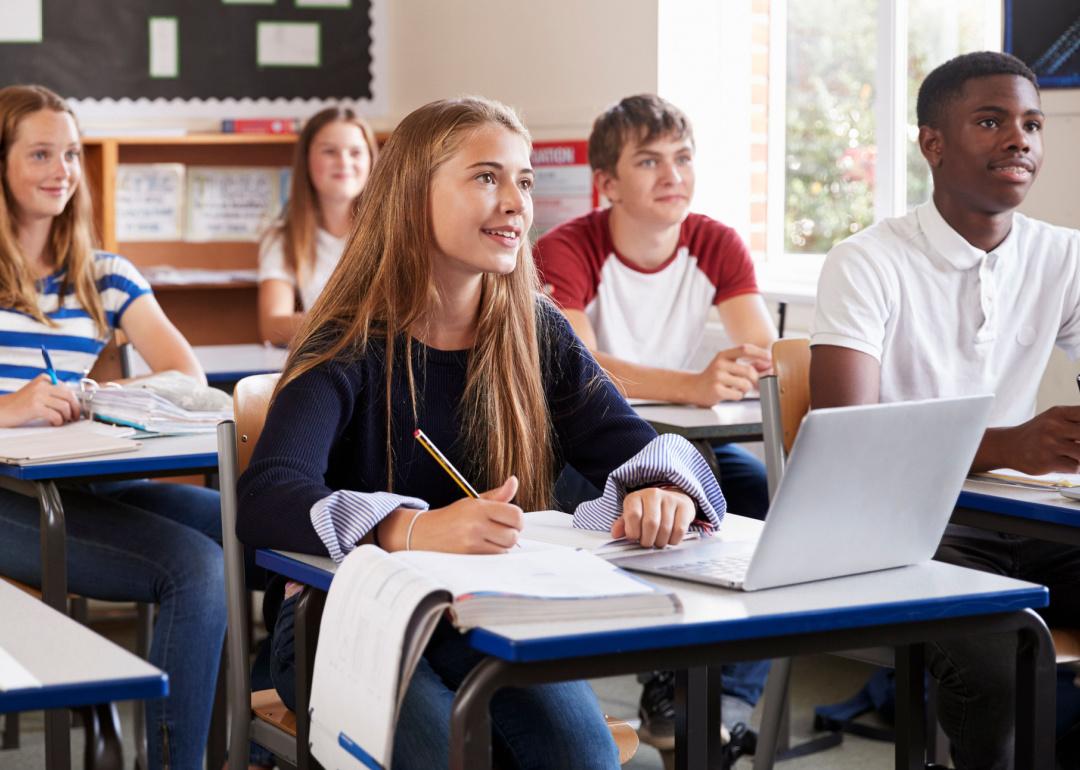 Students seated at desks in classroom.
