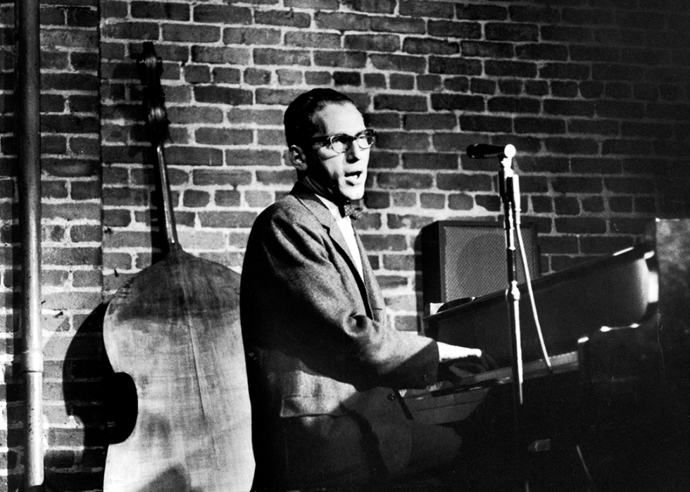 Tom Lehrer performing at piano.
