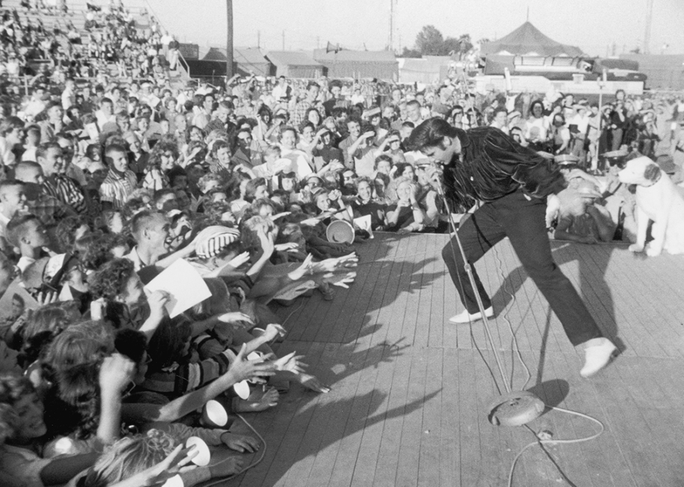 Elvis Presley performing outdoors.
