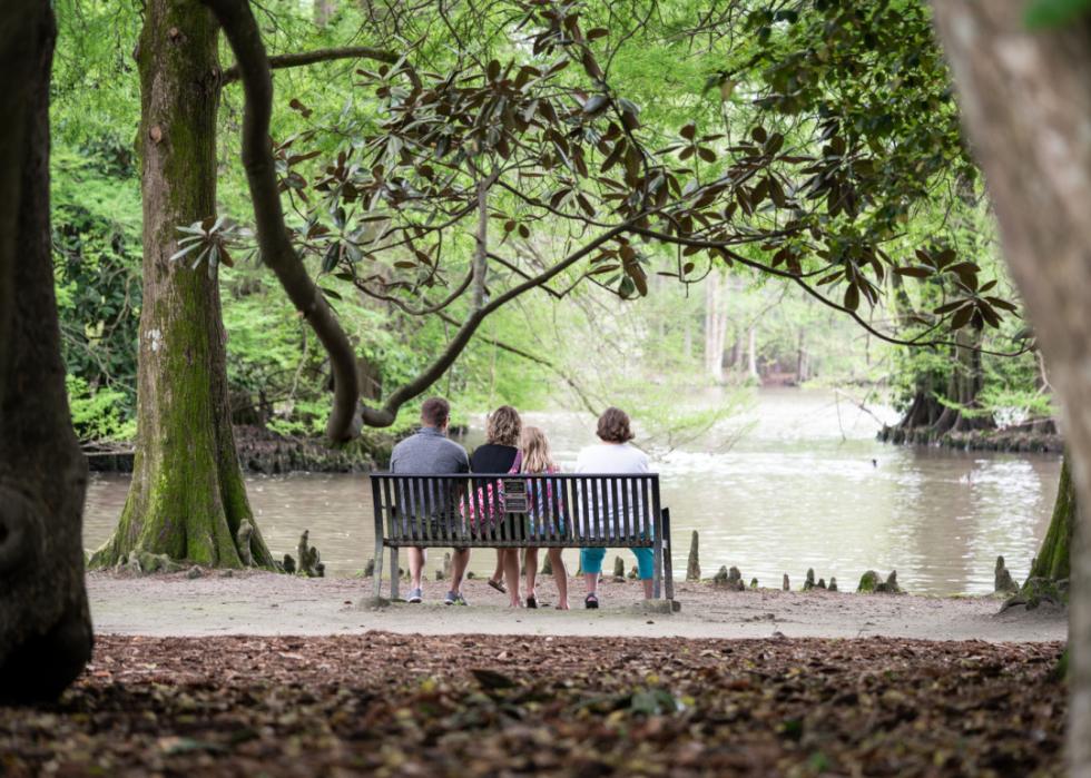 A family on a waterfront bench.