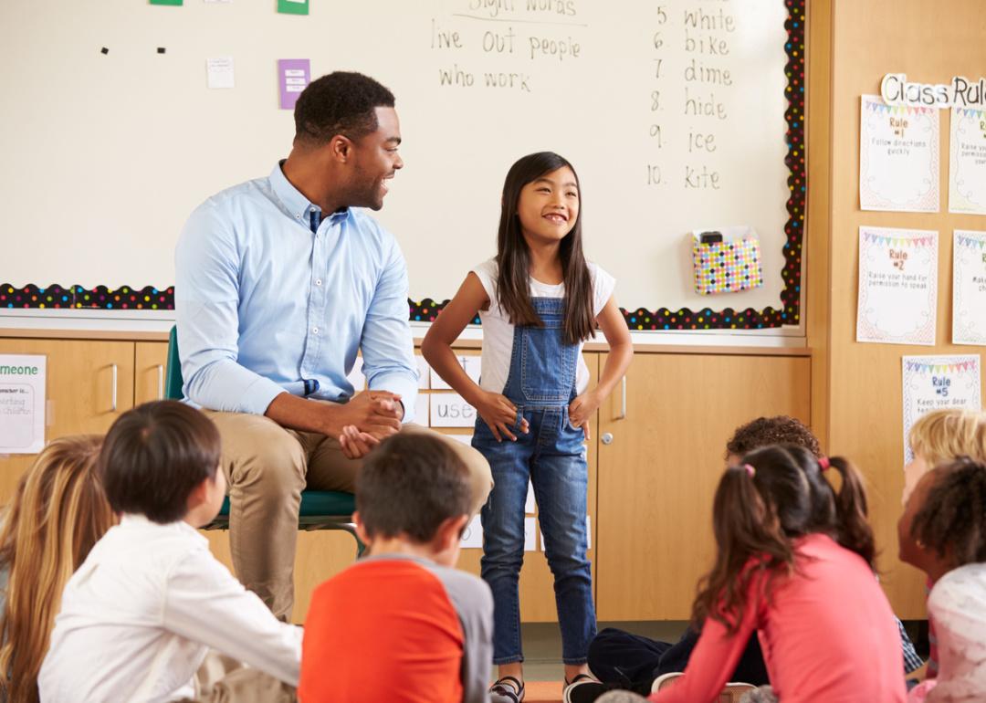 Elementary student and teacher talking to class.