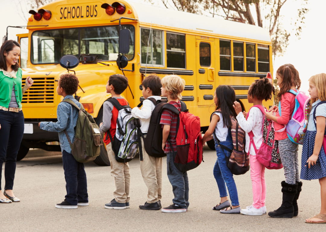 Elementary school students lining up for bus.