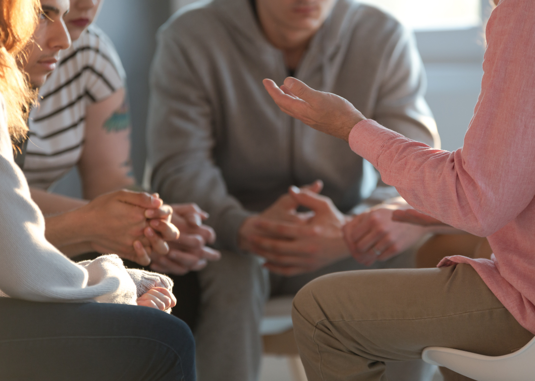 Therapist talking to a group of teenagers.